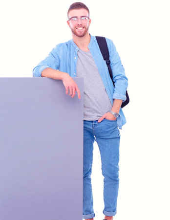 Portrait of a smiling male student holding blank board. Education opportunities. College student.の写真素材