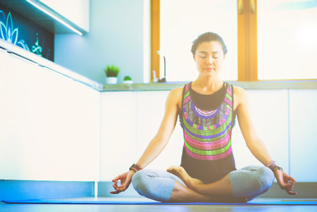 Young woman doing yoga at home in the lotus position. Yoga. Woman. Lifestyleの写真素材