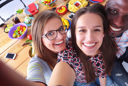 Group of people doing selfie during lunch. Self. Friends. Friends are photographed for eatingの写真素材