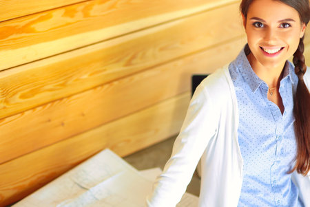 Young female standing near desk at home. The woman at the table. Workplace.の写真素材