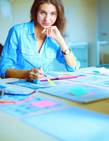 Young woman sitting at office table . Young woman.の写真素材