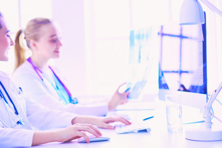 Two young female doctors working on computer at hospital.の写真素材
