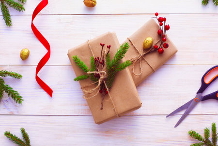 Christmas gift boxes and fir tree branch on wooden table, flat lay. Ð¡hristmas backgroundの写真素材