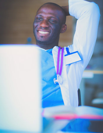 Young african doctor working on laptop at desk. Doctor. Workplaceの写真素材