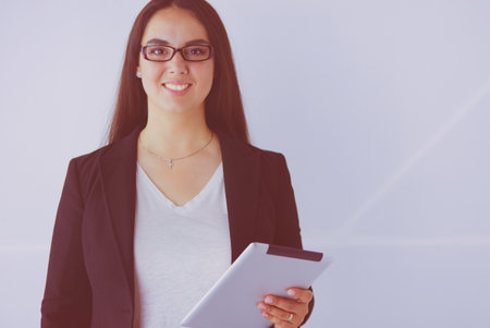 Portrait of smiling young business woman with digital tablet in her hands.の写真素材