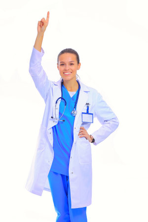 Beautiful young woman in white coat posing with hand in pocket. Woman doctorの写真素材