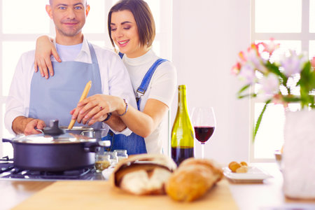 Couple cooking together in the kitchen at homeの写真素材