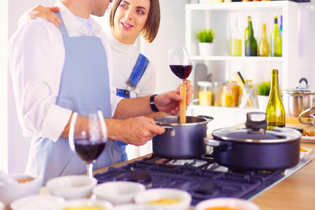 Couple cooking together in the kitchen at homeの写真素材