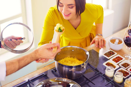 Couple cooking together in the kitchen at homeの写真素材