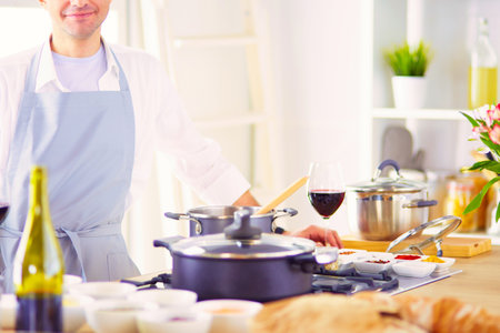 Couple cooking together in the kitchen at homeの写真素材