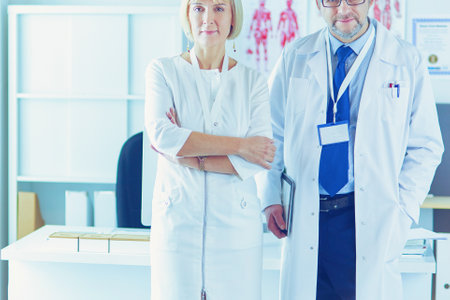 Doctors smiling at camera in medical officeの写真素材