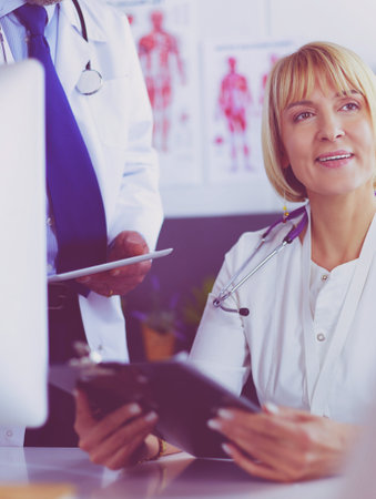 Doctor and nurse working in office at hospitalの写真素材