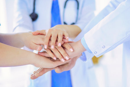 Group of doctors putting their hands together. Close-upの写真素材