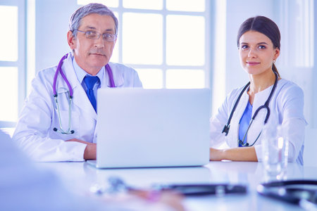 Serious medical team working in a bright officeの写真素材
