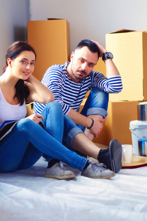 Couple moving in house sitting on the floor . Coupleの写真素材