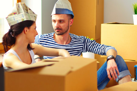 Couple moving in house sitting on the floor . Coupleの写真素材