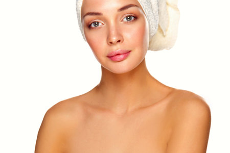 Beautiful woman with a towel on his head on a white backgroundの写真素材