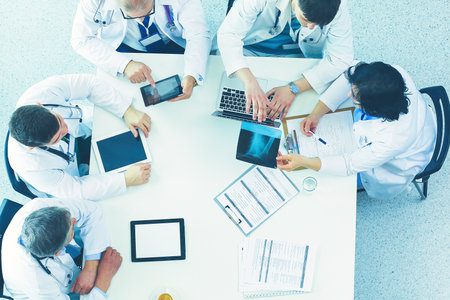 Medical team sitting and discussing at table, top viewの写真素材