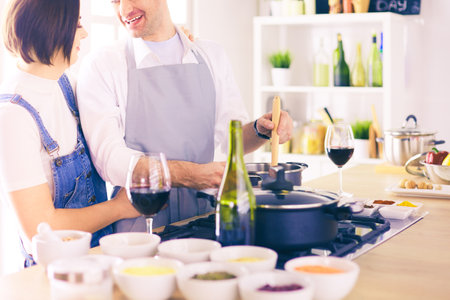 Couple cooking together in the kitchen at homeの写真素材
