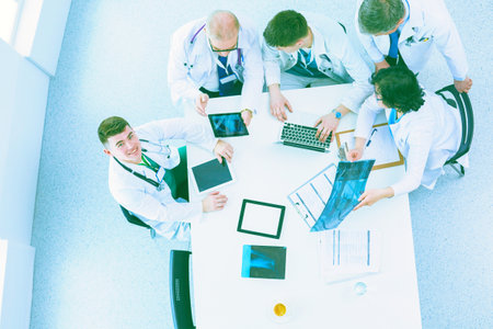 Medical team sitting and discussing at table, top viewの写真素材