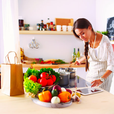 Cooking woman in kitchen with wooden spoon. Cooking womanの写真素材