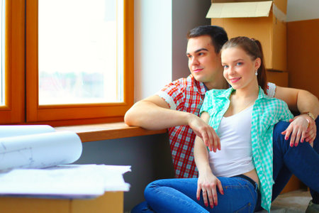 Couple moving in house sitting on the floor. Coupleの写真素材