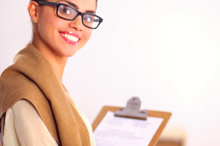 Attractive businesswoman standing near desk in the officeの写真素材