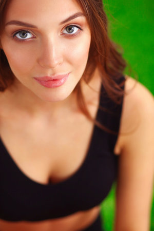 Woman sitting with crossed legs on the green grassの写真素材