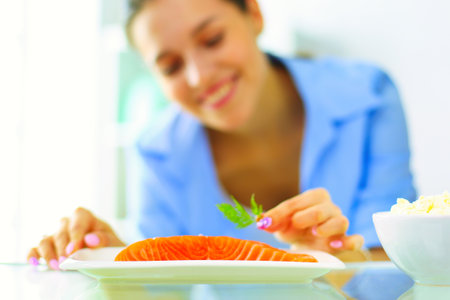 Portrait of female standing near open fridge full of healthy food, vegetables and fruits. Portrait of femaleの写真素材