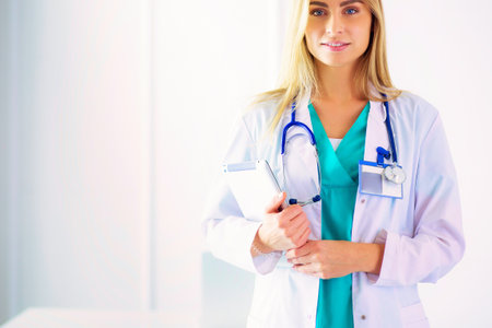 Portrait of confident female doctors standing with arms crossed at the medical officeの写真素材