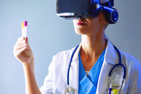 Female doctor wearing virtual reality glasses isolated on white background.の写真素材