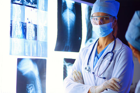 Image of attractive woman doctor looking at x-ray results.の写真素材