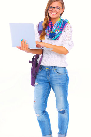 Smiling teenager with laptop on white background. Student.の写真素材