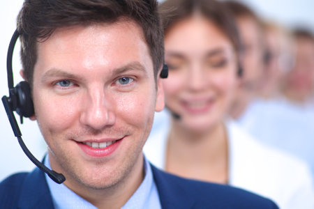 Attractive positive young businesspeople and colleagues in a call center officeの写真素材