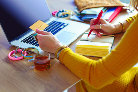 Young woman on a coffee break or enjoying the coffee-break, Using laptop computer.の写真素材