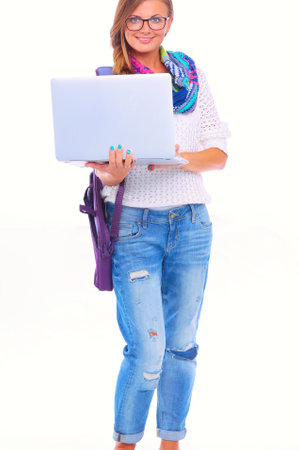 Smiling teenager with laptop on white background. Student.の写真素材