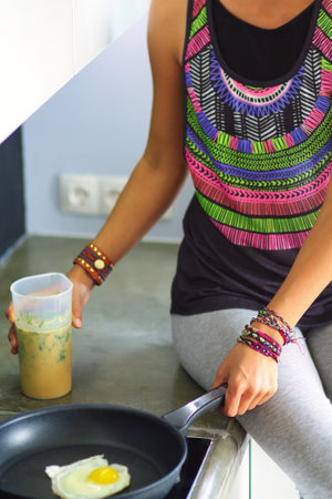 Fitness girl cooking healthy food in the kitchen. Woman. Kitchen. Cookingの写真素材