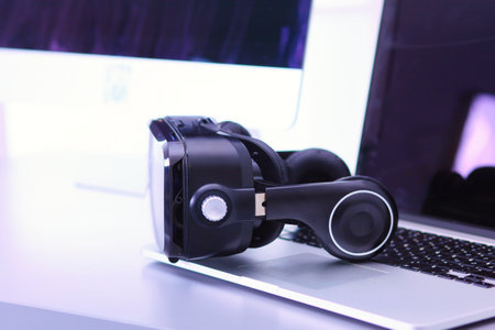 Virtual reality goggles on desk with laptop. business. 3d technologyの写真素材