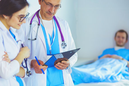 A medical team of doctors, man and woman,standing in hospitalの写真素材