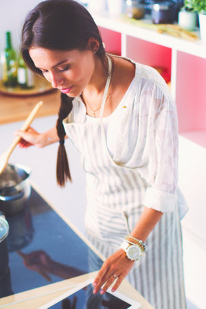 Cooking woman in kitchen with wooden spoon. Cooking womanの写真素材