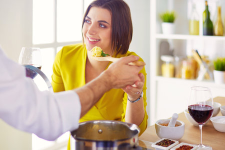 Couple cooking together in the kitchen at homeの写真素材