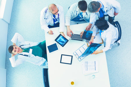 Medical team sitting and discussing at table, top viewの写真素材