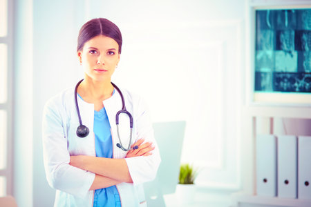 Young smiling female doctor with stethoscope at doctors officeの写真素材