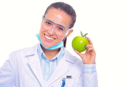 Dentist medical doctor woman hold green fresh apple in hand and tooth brush. Dentist doctors. Woman doctorsの写真素材