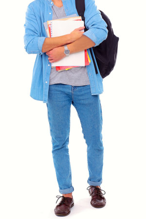 A male student with a school bag holding books isolated on white background. Education opportunities. College student.の写真素材