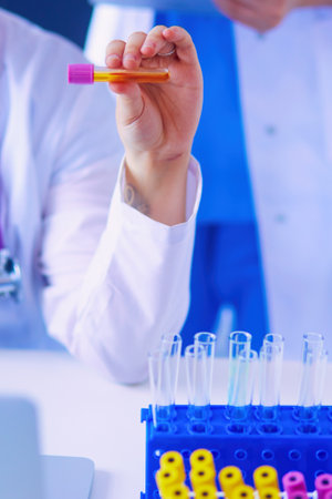 Laboratory assistant holding test tube.の写真素材