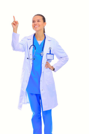 Beautiful young woman in white coat posing with hand in pocket. Woman doctorの写真素材