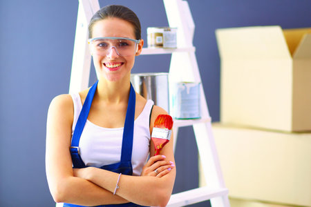 Happy beautiful young woman doing wall paintingの写真素材