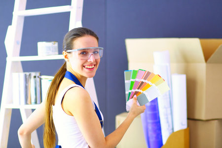 Happy beautiful young woman doing wall paintingの写真素材