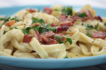 Fresh and beautiful fettuccine carbonara on blue plate.の写真素材